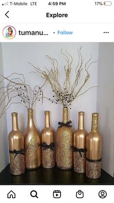 there are many bottles that have been decorated with gold glitter and black ribbon on them