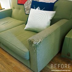 a green couch with some pillows on it