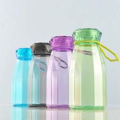 four different colored plastic water bottles lined up