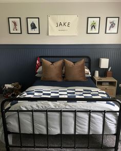 a bed sitting in a bedroom next to two framed pictures on the wall above it