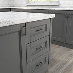 a kitchen island with marble top and drawers