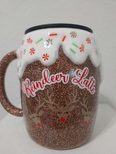 a coffee mug decorated with reindeer and snowflakes on the inside, says reindeer lake