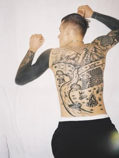 a man with tattoos on his back and arms