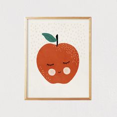 an apple with eyes closed and a green leaf on it's tip is framed in a white wall