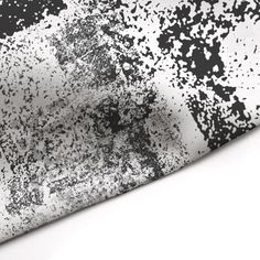 black and white paint splattered on fabric