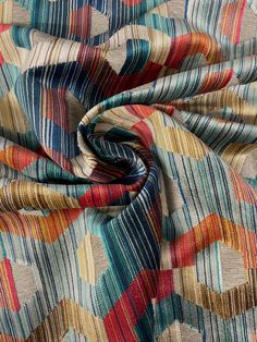 a multicolored fabric with an abstract design on it's side and the bottom