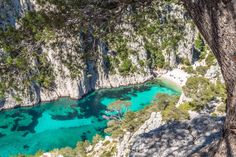 the blue water is surrounded by trees and rocks