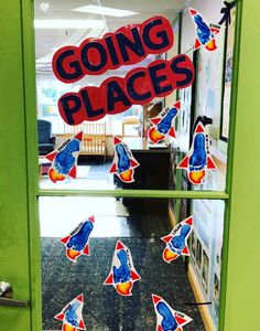 an open door with stickers on it that say going places and rocket rockets flying in the sky