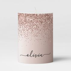 a candle with the word aluna written on it in black ink and gold glitters