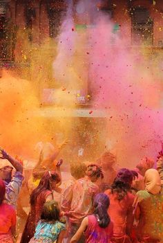 people are throwing colored powder on each other