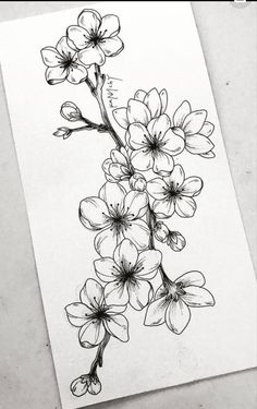 a black and white drawing of flowers on a piece of paper