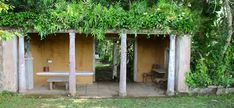 an outdoor area with benches and plants on the walls