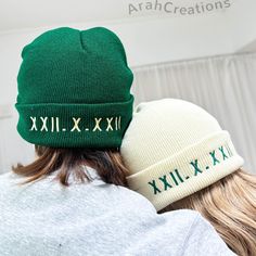 two people wearing beanies that say xxii and xxii