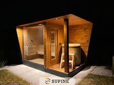 an outdoor sauna is lit up at night