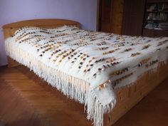 a bed with fringes on it in a room