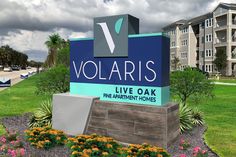 the sign for volaris in front of a building with flowers and palm trees