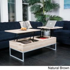 a living room filled with furniture and a laptop computer on top of a coffee table