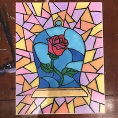 a stained glass window with a rose on it