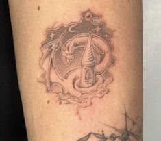 a close up of a person's arm with a tattoo on it and an arrow in the middle