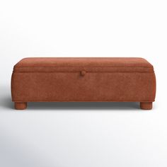 an orange bench with wooden legs and a button on the top, in front of a white background