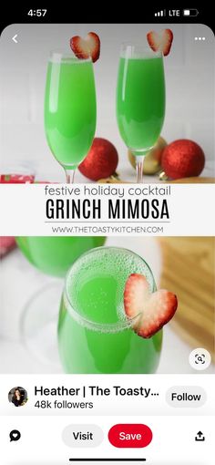 two glasses filled with green liquid and strawberries on top of each other in front of a