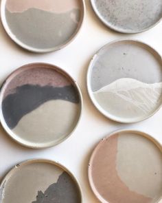 six plates with different shades of paint on them