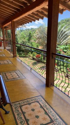 an outdoor area with tile flooring and railings on the outside side of it