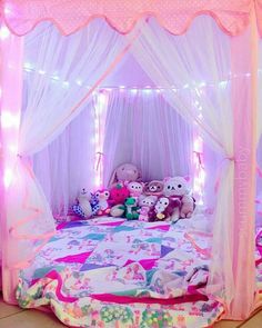 a pink bed with white curtains and stuffed animals on the bottom layer, in a room that looks like it has been turned into a princess's bedroom