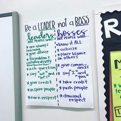 a white refrigerator freezer sitting inside of a kitchen next to a sign that says be a leader not a boss