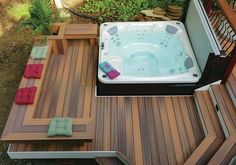 a hot tub sitting on top of a wooden deck