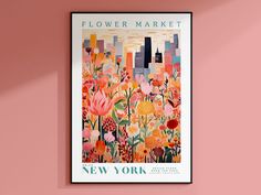 a flower market poster hangs on the wall in front of a pink painted wall with flowers