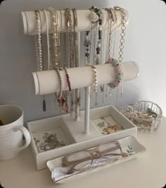 a pair of glasses is sitting on a tray with bracelets and eyeglasses