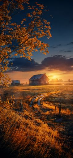 the sun is setting over an old farm house on a country road with trees in the foreground