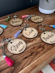 personalized wooden keychains with tassels on a table