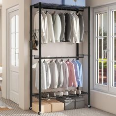 an open closet with clothes and shoes hanging on the rack, next to a window