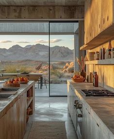 an open kitchen with mountains in the background