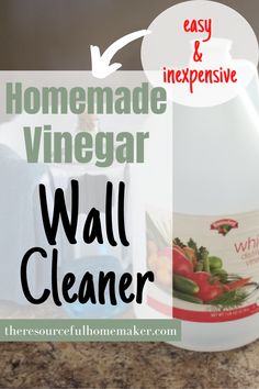 a bottle of vinegar sitting on top of a counter next to a canister with the words homemade vinegar wall cleaner