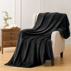 PRICES MAY VARY. SOFT FABRIC - This luxurious blanket is made of 300 GSM microfiber. The fabric is warm and skin-friendly. The blanket is a good choice for you to give your friends or family members as a gift. It could also be used as a pet blanket. LARGE SIZE - This black flannel throw blanket measures 50x70 inch, it could cover all over your body. UNIQUE DESIGN - This horizontal stripe pattern couch blanket would make your room modern and elegant, perfect matching with your home decor. It can Black Throw Blanket Couch, Stripe Couch, Fluffy Black Blanket, Black Cozy Blankets, Pattern Couch, Black Fur Blanket, Black Queen Blanket, Striped Couch, White Coffee Table Modern