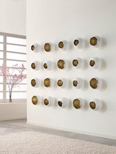 a white wall with gold circles on it