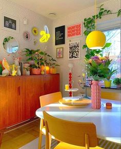 a dining room filled with lots of furniture and plants