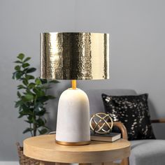 a table with a lamp on it next to a couch