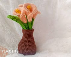 a crocheted vase with flowers in it on a white background, that is knitted to look like yarn