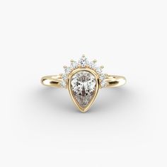 a pear shaped diamond ring with three stone accents