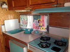 a kitchen with a stove top oven and wooden cabinets