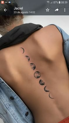 the back of a woman's neck with phases on it