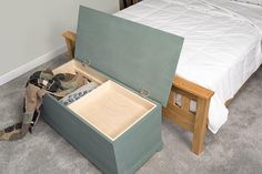 an open suitcase sitting on the floor next to a bed