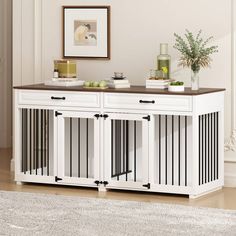 a white sideboard with two doors and some fruit on top in a living room