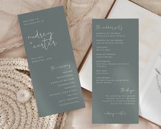 two wedding programs are laying next to each other on a table with a straw bag