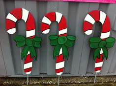 three candy canes painted to look like they are on the side of a building