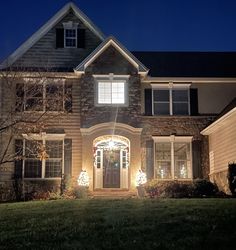 a house is lit up with christmas lights